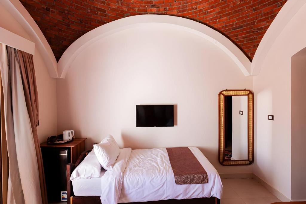 Postel nebo postele na pokoji v ubytování Aro Kato Nubian Guest House