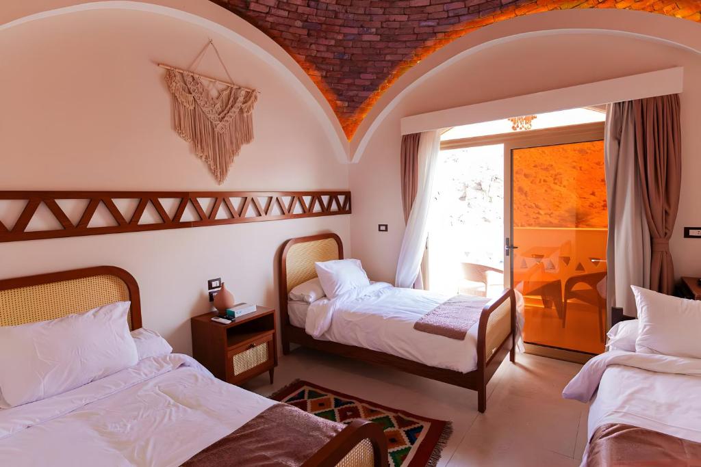 Postel nebo postele na pokoji v ubytování Aro Kato Nubian Guest House