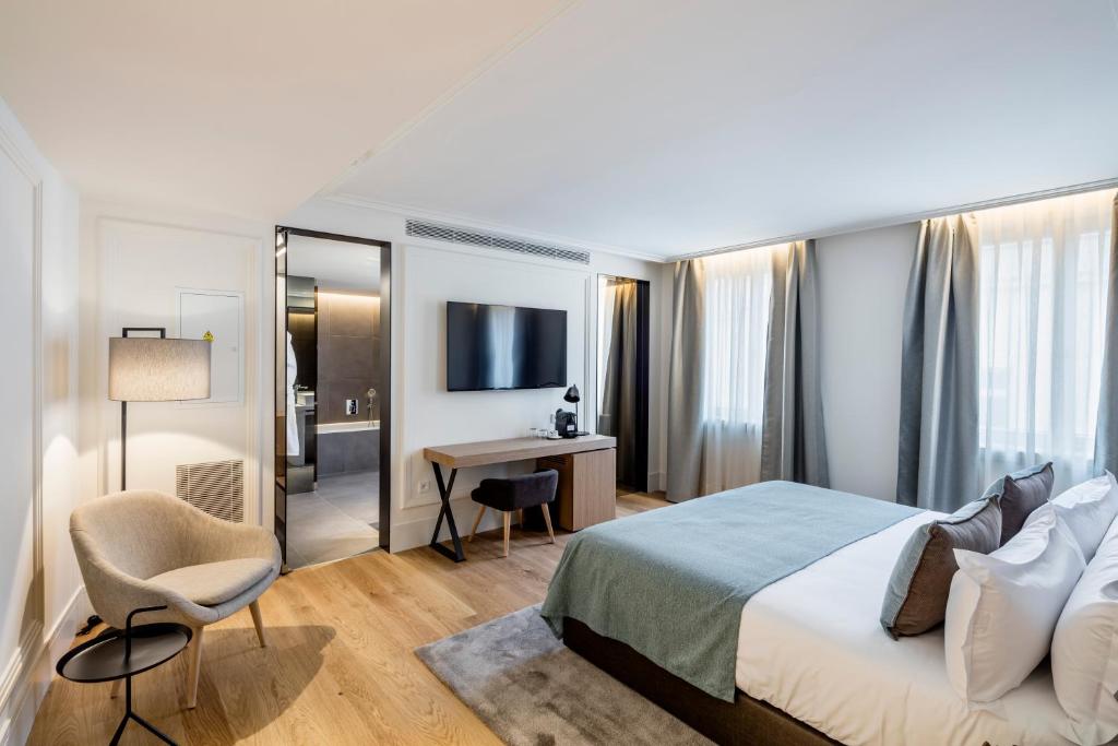 a hotel room with a bed and a desk at BoHo Prague Hotel - Small Luxury Hotels in Prague