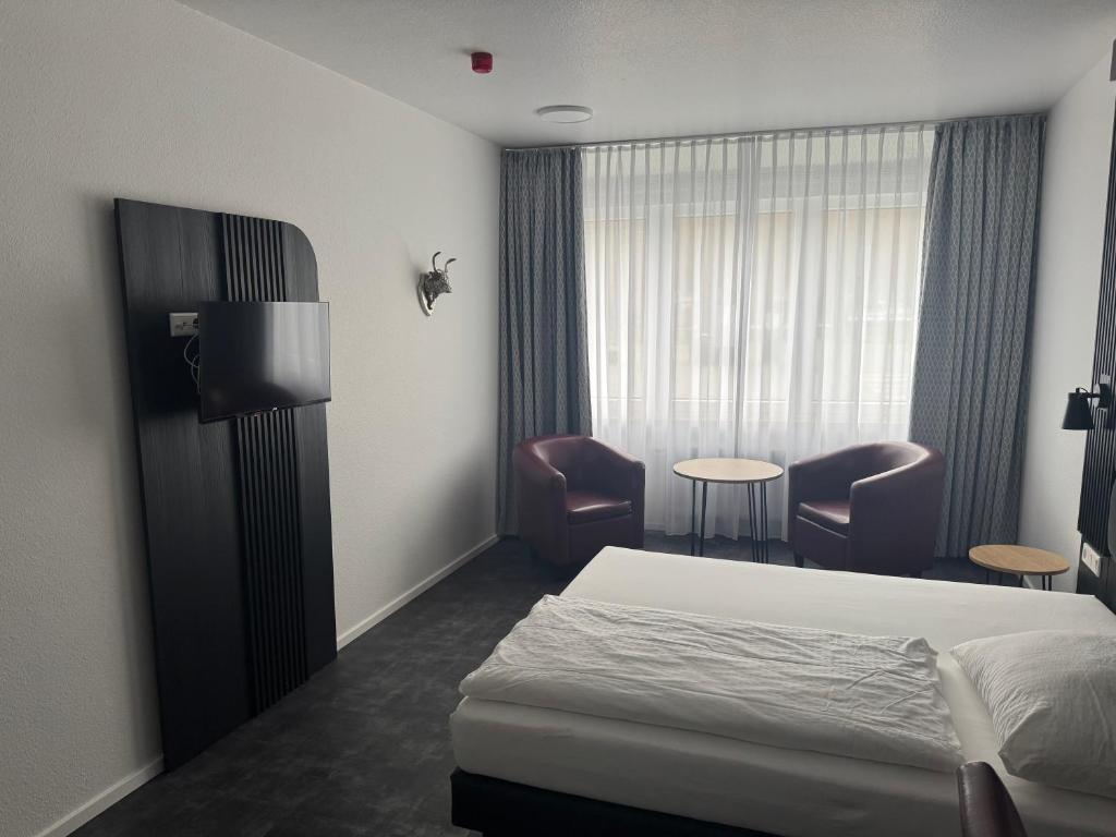 Postel nebo postele na pokoji v ubytování Panorama Hotel Rheinkrone