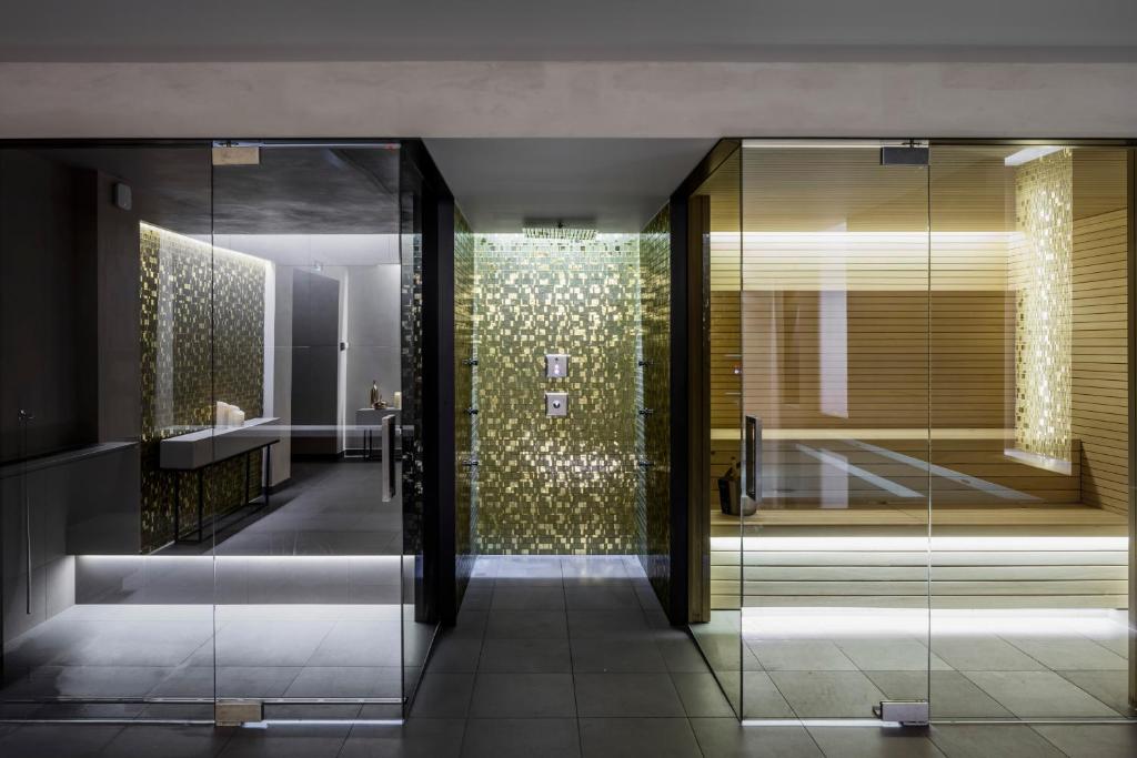 a bathroom with a shower with a glass door at BoHo Prague Hotel - Small Luxury Hotels in Prague