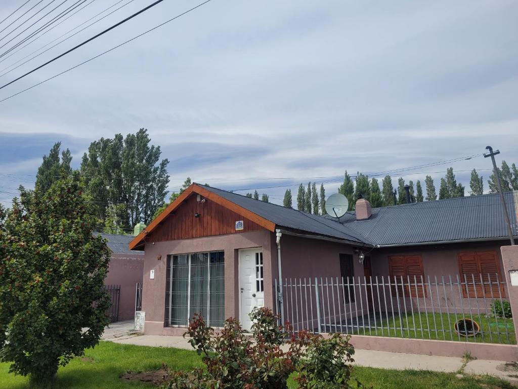 a red house with a black roof at Avenida Centro in Los Antiguos