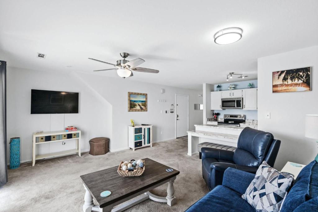 a living room with a couch and a table at 215 C2 GP-The Treehouse in Coffeyville