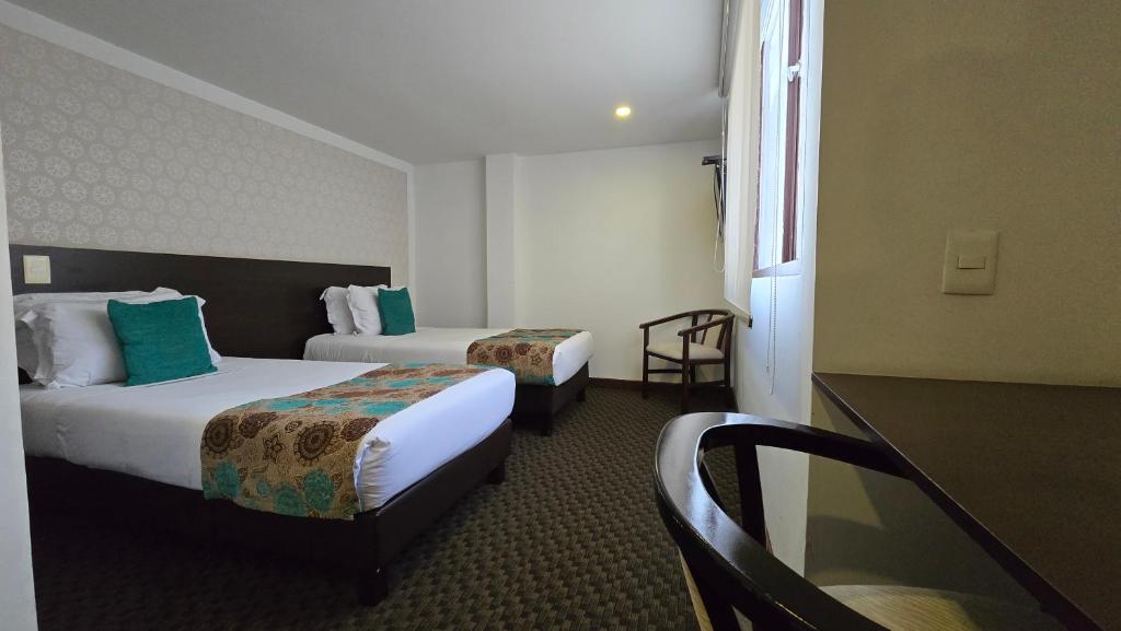 Postel nebo postele na pokoji v ubytování Castellana 95 Bogota By Hoteles Confort 80
