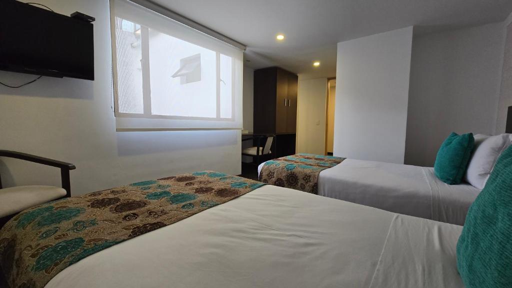 Postel nebo postele na pokoji v ubytování Castellana 95 Bogota By Hoteles Confort 80