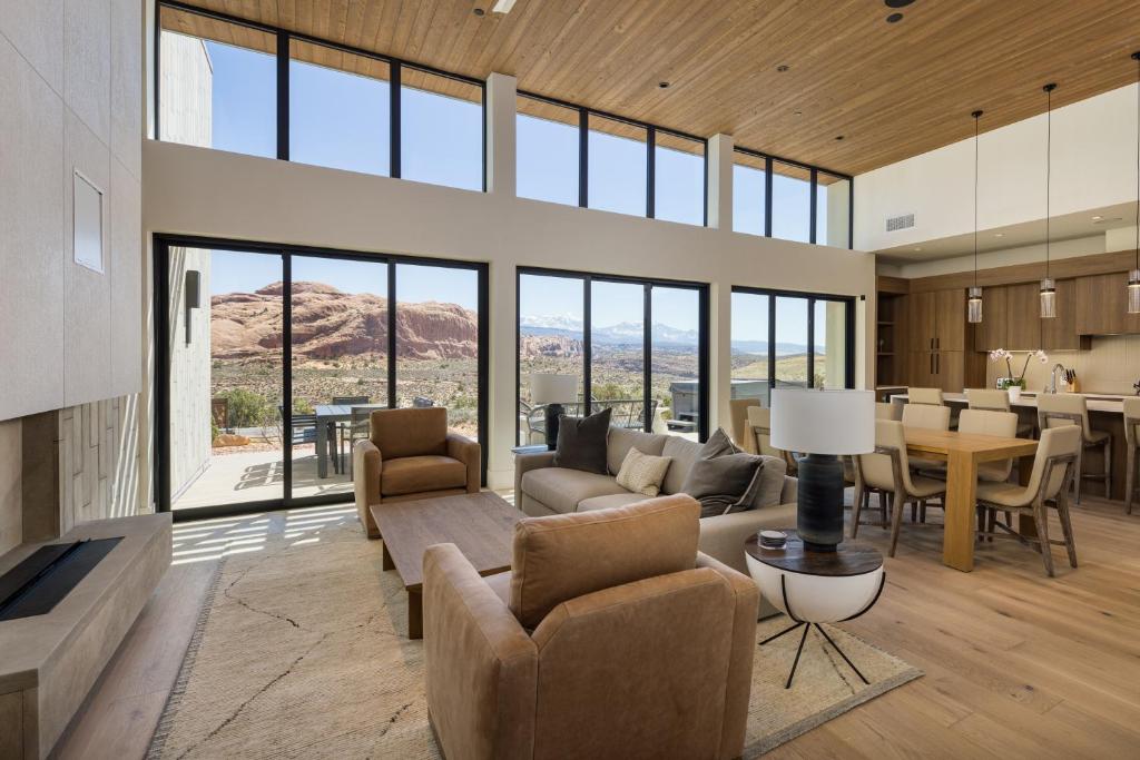 a living room with a couch and chairs and a table at LIONSBACK RESORT in Moab