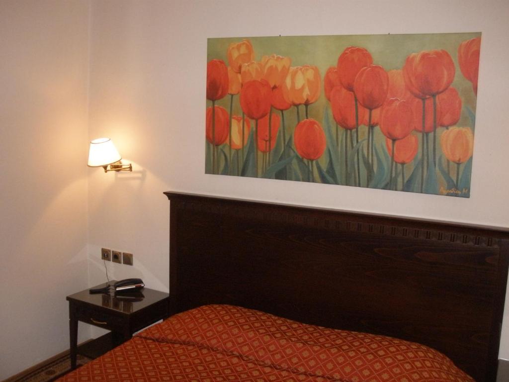 Postel nebo postele na pokoji v ubytování Pelias Hotel