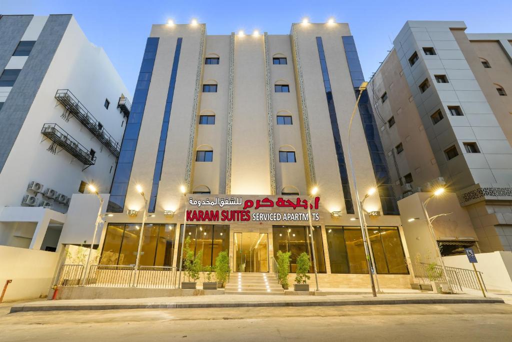 a large building with a sign in front of it at New Karam Suites in Riyadh