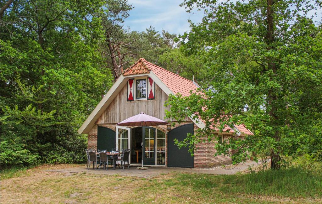 a small house with a table and chairs in front at Hawar in De Bult