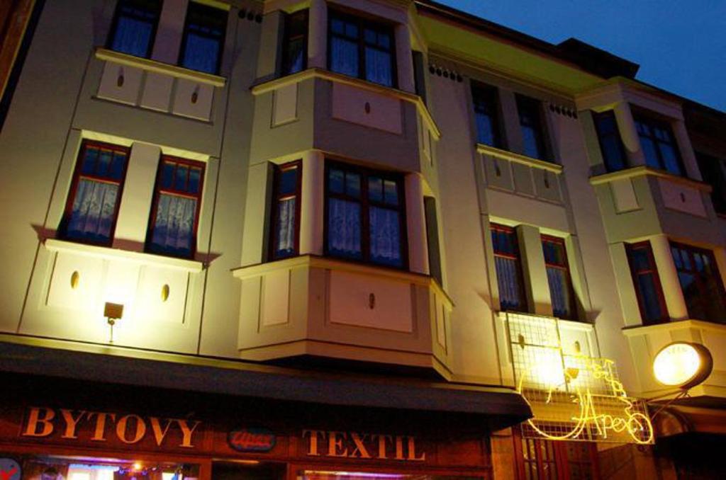 a large building with lit up windows at night at Penzion-Apex in Kdyně