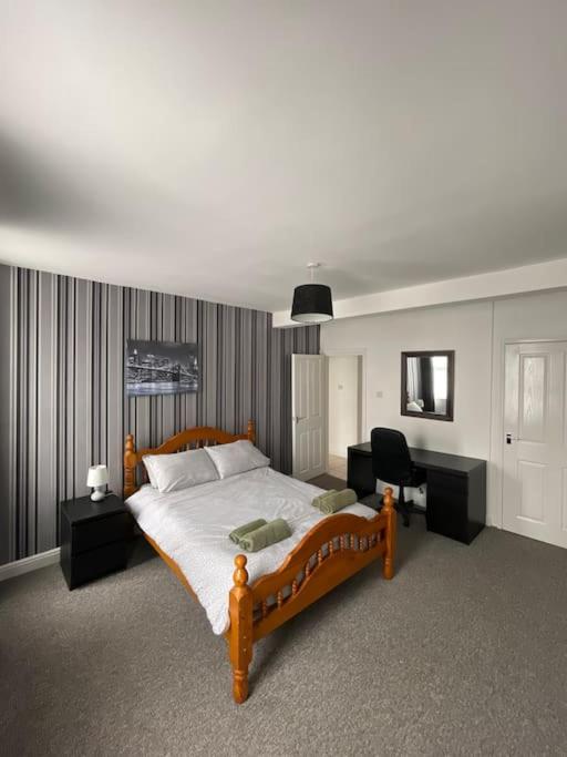 a bedroom with a large bed and a desk at Spacious Property For Hols Base & Contractors Long or Short Stays C2C Western Lakes in Cleator Moor