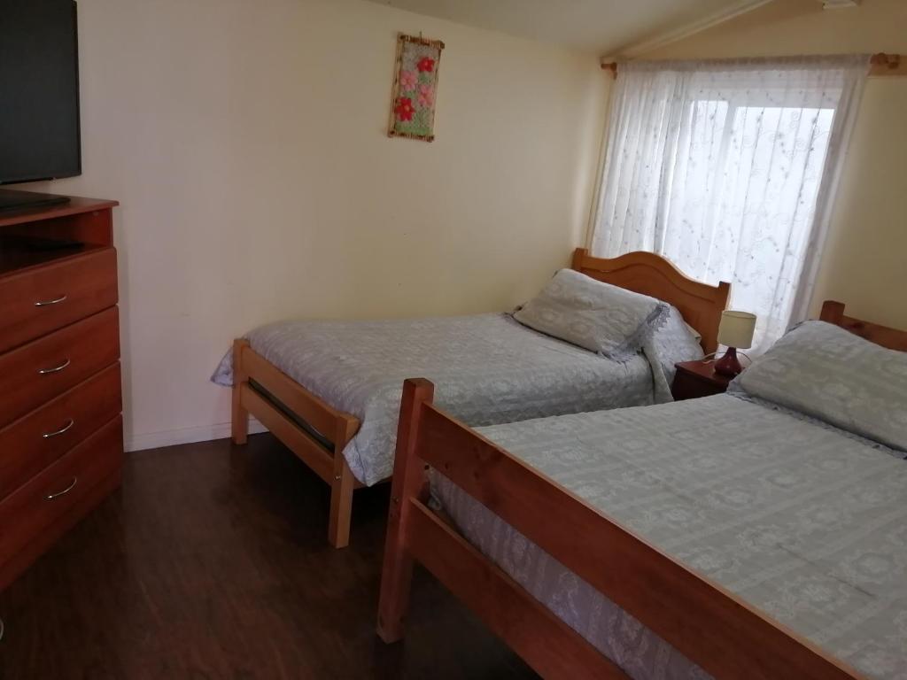 En eller flere senge i et værelse på Cabaña Patagonia Rustica