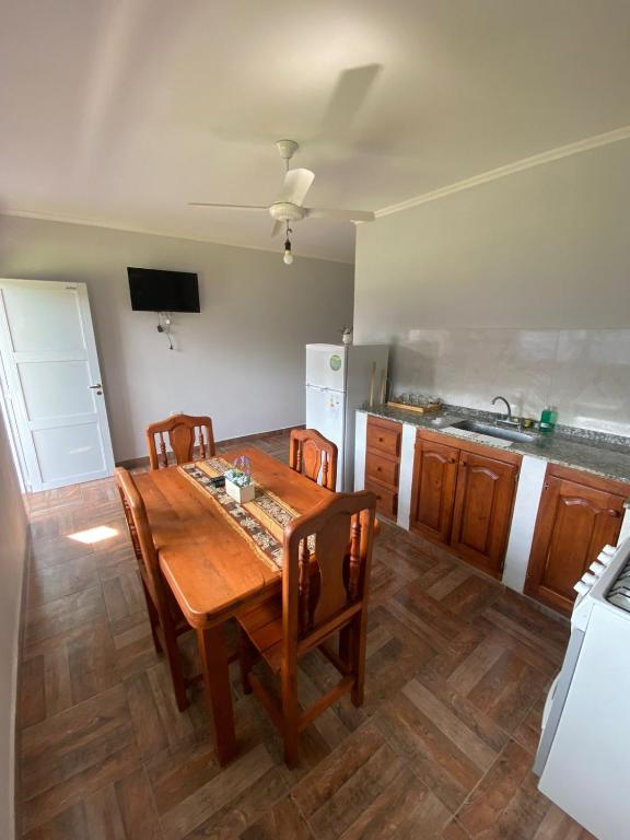 a kitchen with a wooden table and chairs in it at El Despertar in Concepción del Uruguay