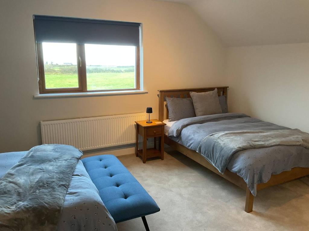 Postel nebo postele na pokoji v ubytování Hazeltree Lodge