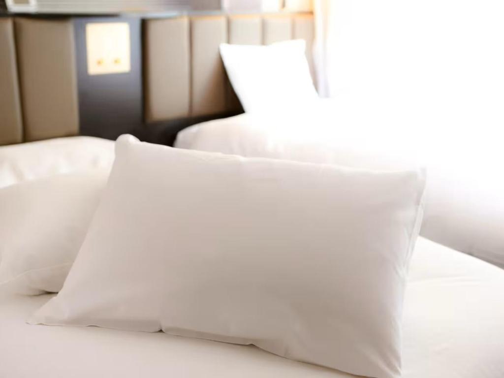 Postel nebo postele na pokoji v ubytování APA Hotel Shonan Tsujido Ekimae