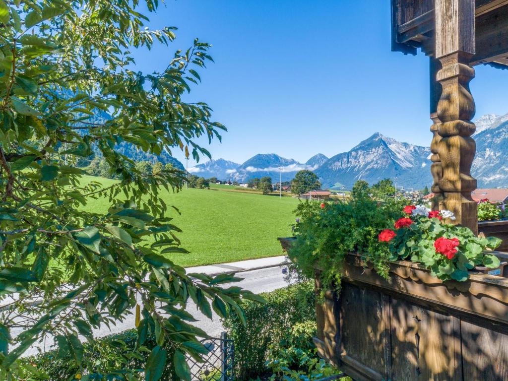 a balcony with a view of a field and mountains at Johanna und Sonja in Reith im Alpbachtal