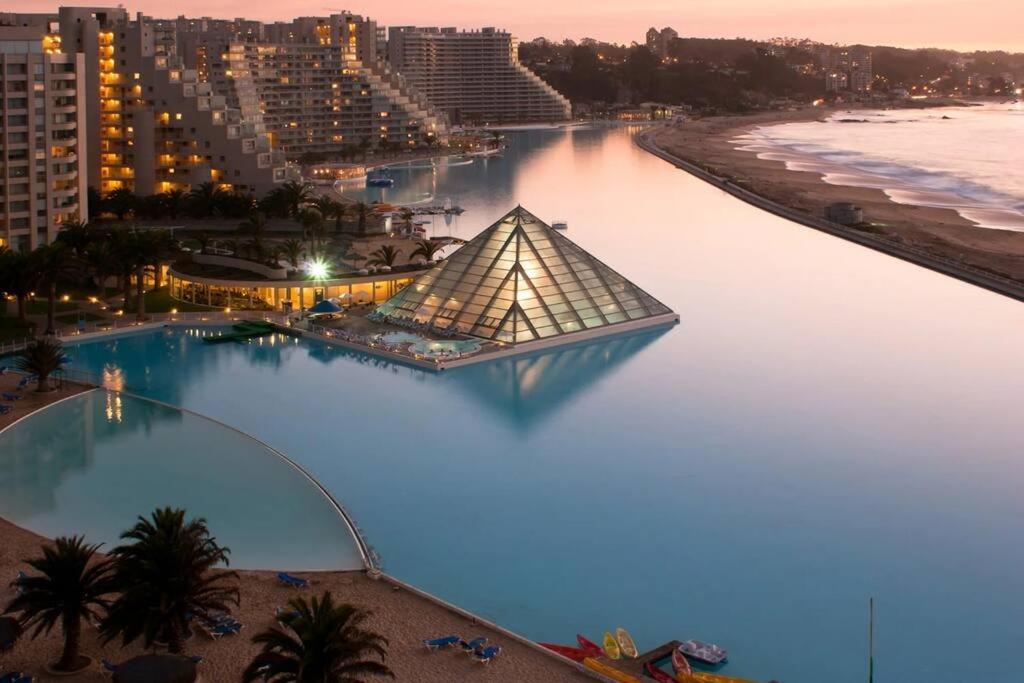 a pyramid in the water next to a beach at Modern San Alfonso del Mar - BBQ Parking Pool Wifi in Algarrobo