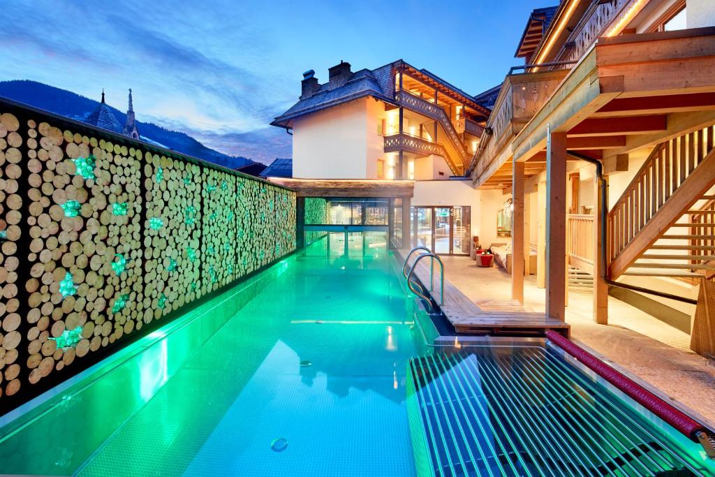 a swimming pool in the backyard of a house at Lifestyle Hotel eder in Maria Alm am Steinernen Meer