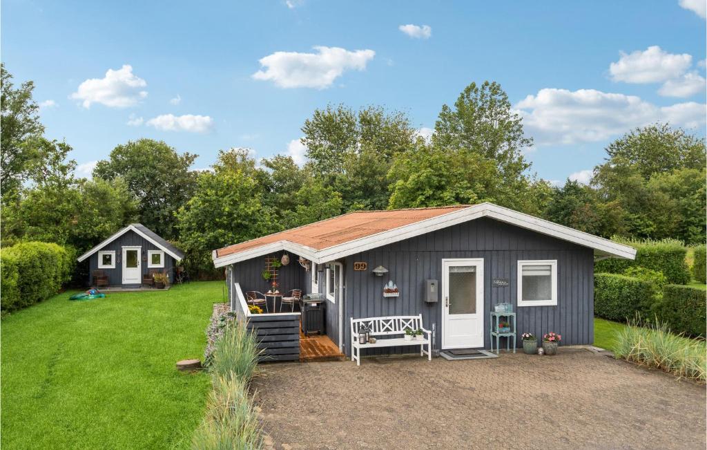 a gray shed with a red roof on a yard at Amazing Home In Hemmet With Wifi in Hemmet