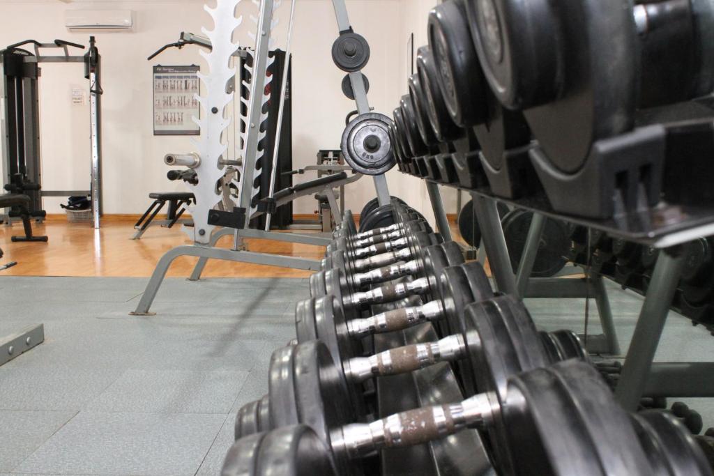 a gym with a bunch of dumbbells at Panglao Regents Park Resort in Panglao