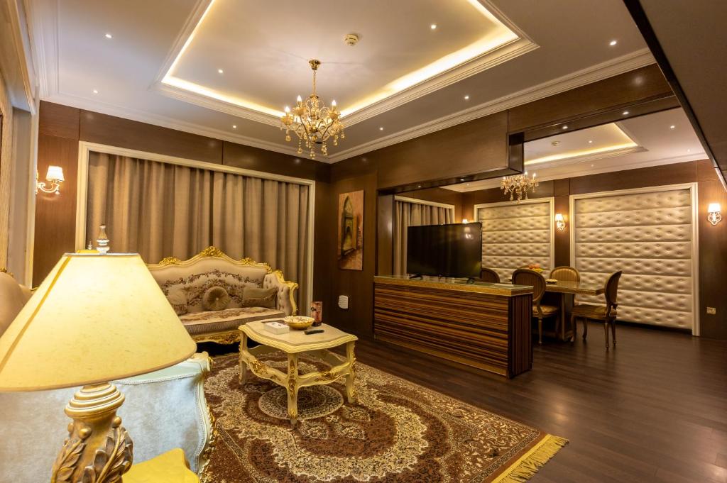 a living room with a couch and a table at Ras Al Khaimah Hotel in Ras al Khaimah
