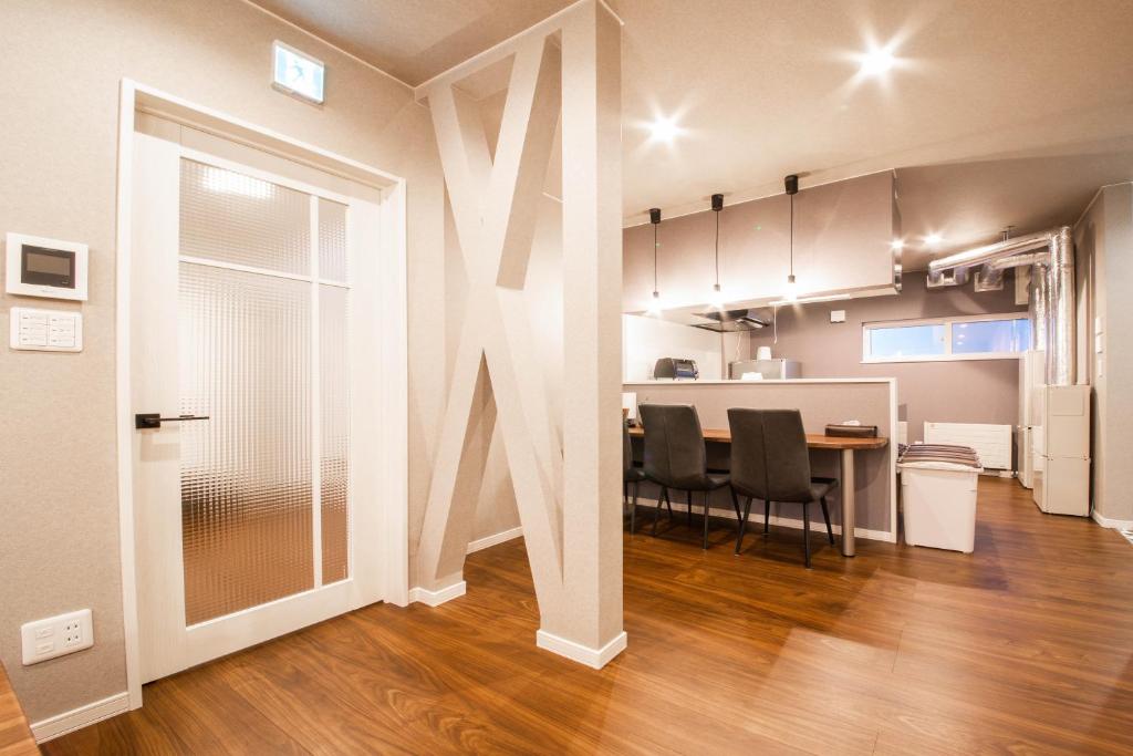 a living room with a table and chairs in a room at THE SUN LOUNGE in Kushiro
