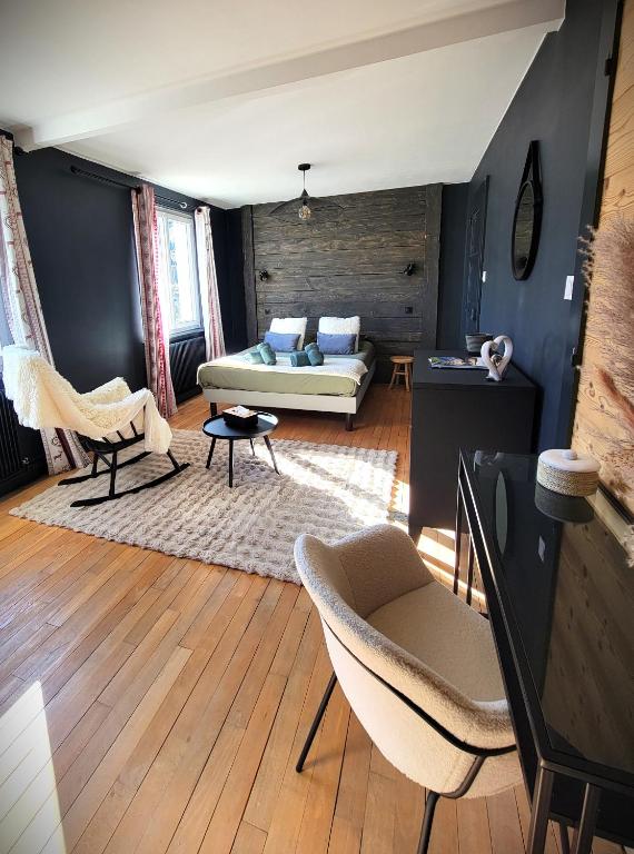 un salon avec un canapé et des chaises dans l'établissement Maison Les Planches, à Gérardmer