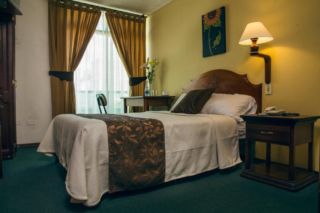 Postel nebo postele na pokoji v ubytování Hotel Podocarpus