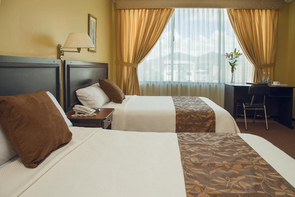 Postel nebo postele na pokoji v ubytování Hotel Podocarpus