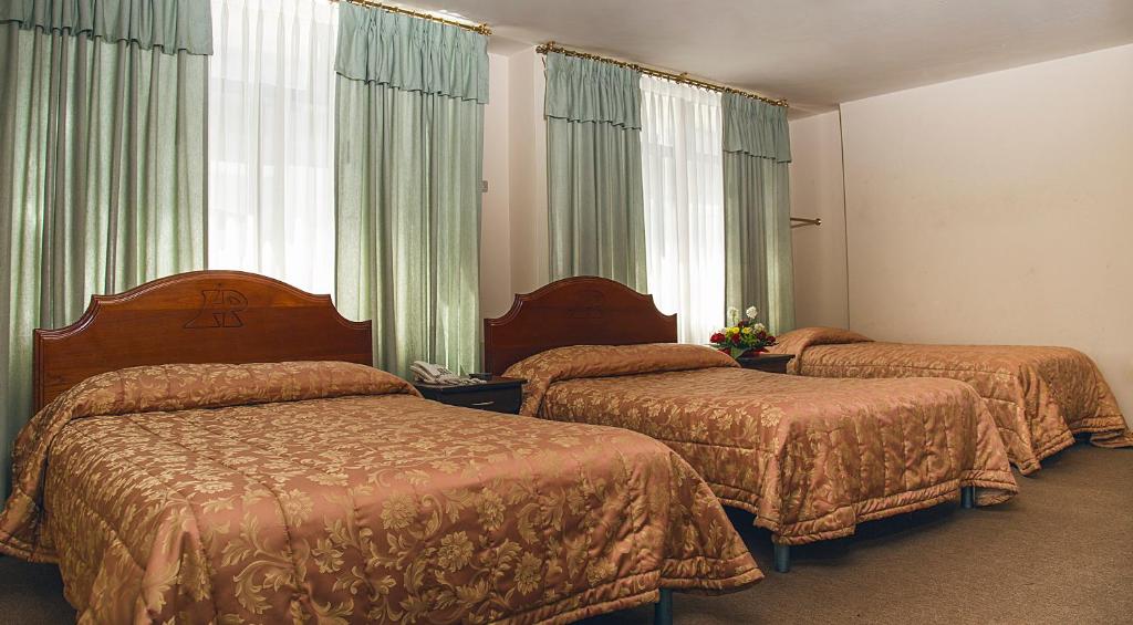 Postel nebo postele na pokoji v ubytování Hotel Podocarpus