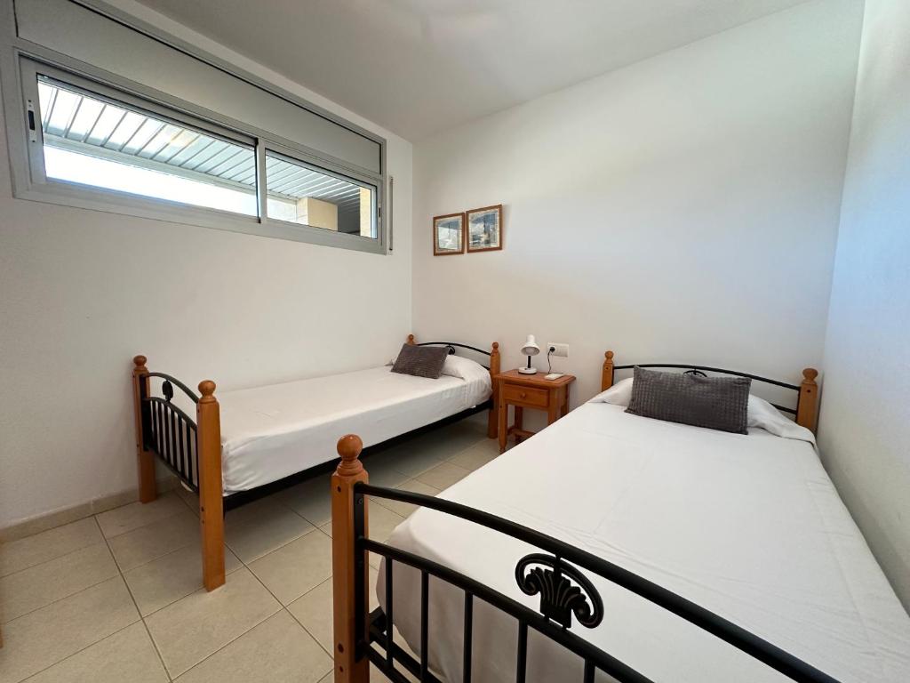 Postel nebo postele na pokoji v ubytování Agi Torre Quimeta Apartments