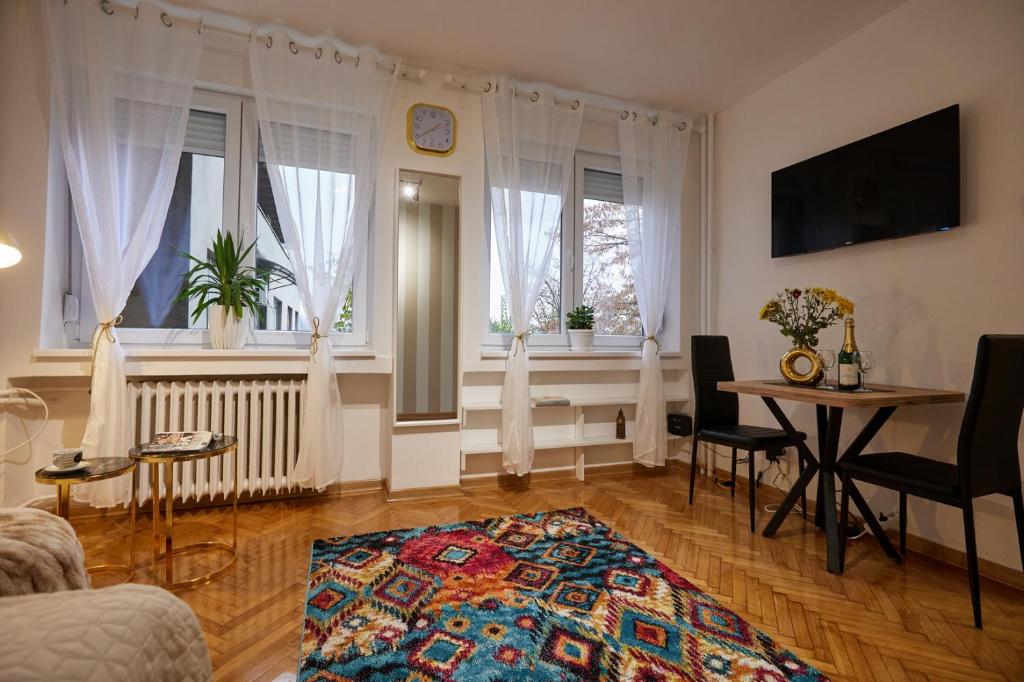 a living room with a table and some windows at Best choice Hram centar in Belgrade