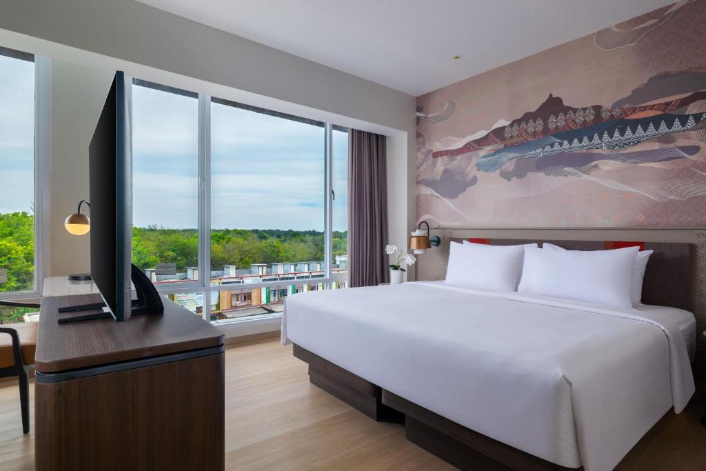 Postel nebo postele na pokoji v ubytování Hotel Santika Lahat