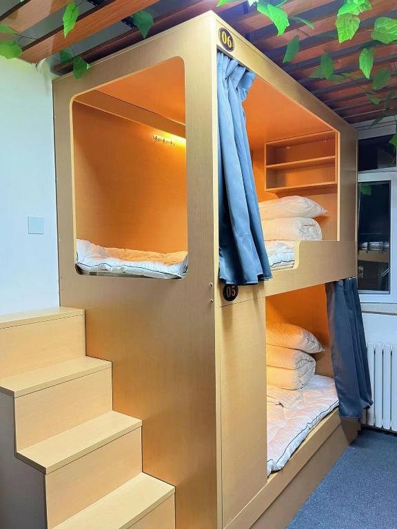 Postel nebo postele na pokoji v ubytování Zhihexing Youth Hostel-知和行青年酒店