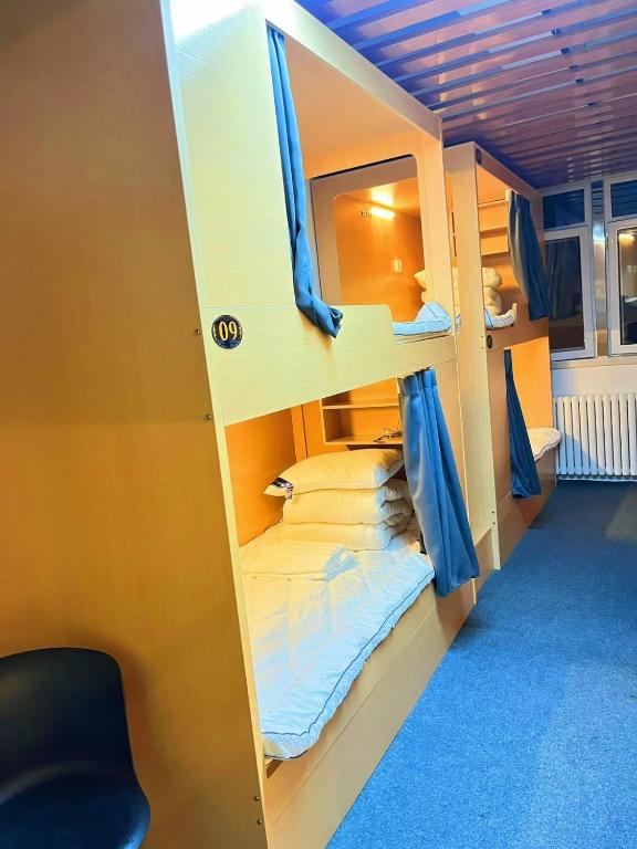 Postel nebo postele na pokoji v ubytování Zhihexing Youth Hostel-知和行青年酒店