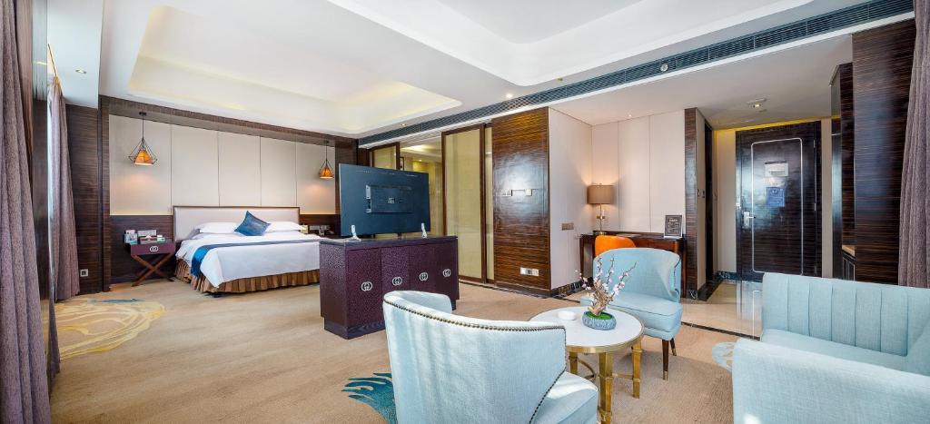 Postel nebo postele na pokoji v ubytování Dongguan Kai Benli International Hotel