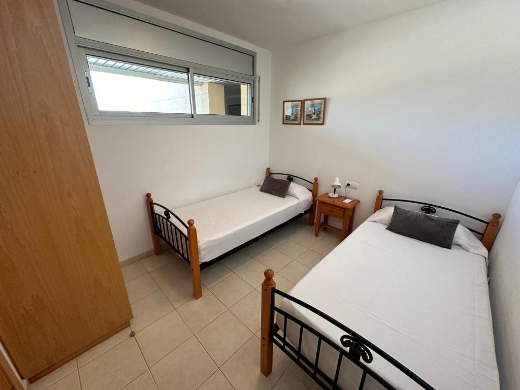 Postel nebo postele na pokoji v ubytování Agi Torre Quimeta Apartments