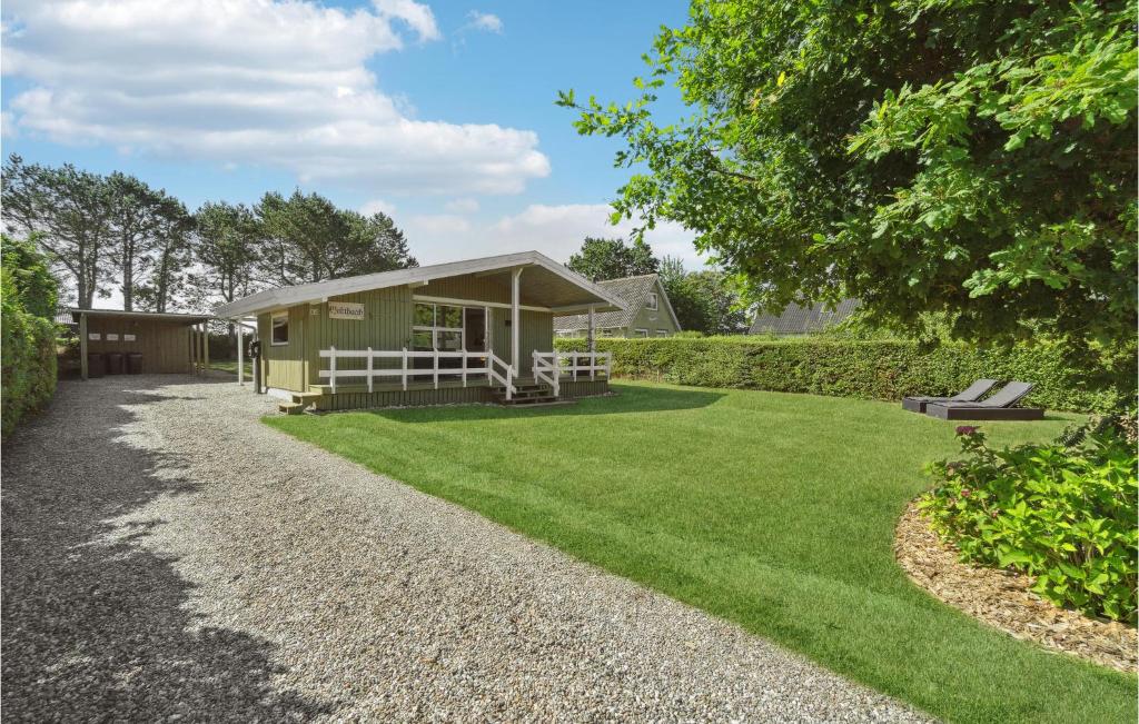 a small green building with a grass yard at Stunning Home In Bogense With Wifi in Bogense