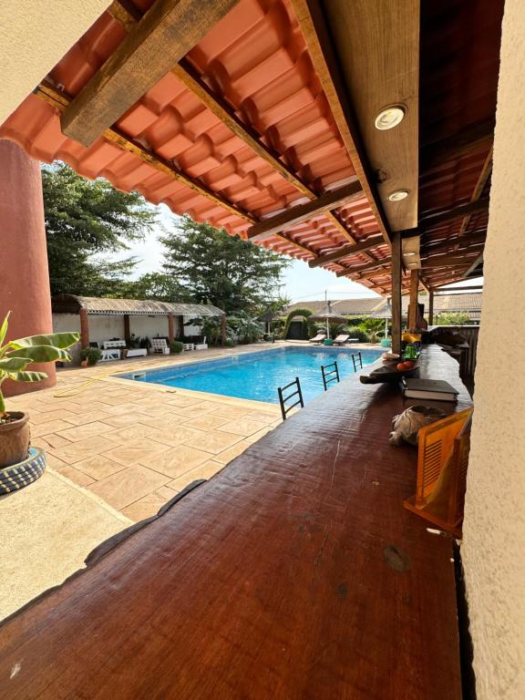 an outdoor patio with awning and a swimming pool at Kayzen house in Ngaparou