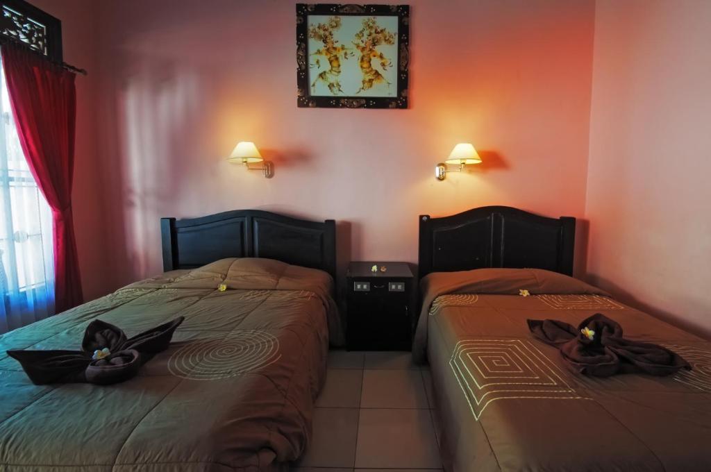 Postel nebo postele na pokoji v ubytování Pesona Beach Inn