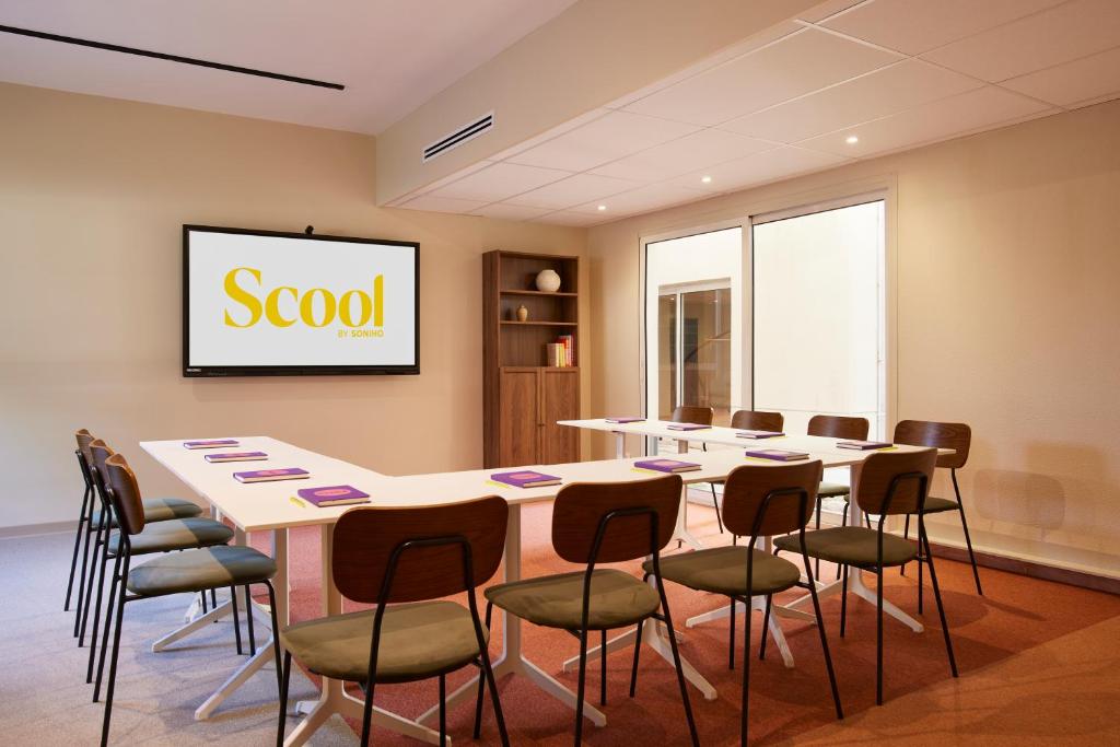 a conference room with a long table and chairs at Hotel des Victoires - Restaurant in Cannes