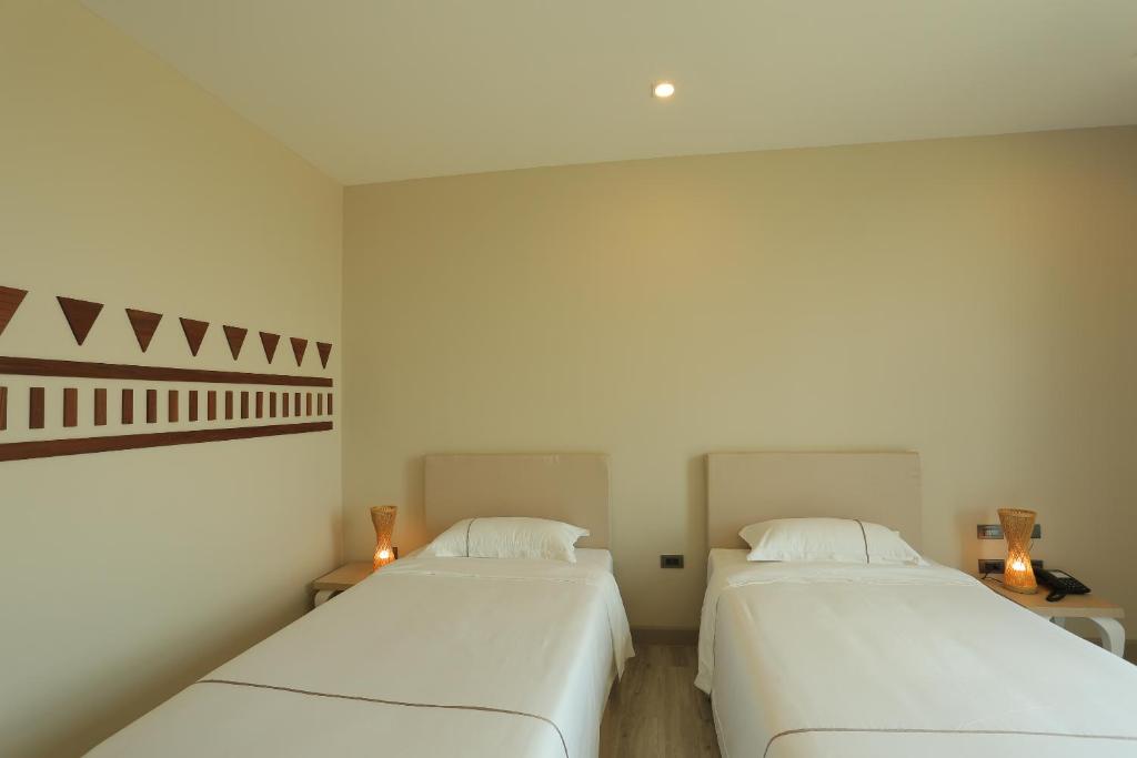 Postel nebo postele na pokoji v ubytování Navela Hotel & Convention