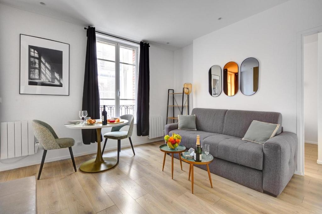 un salon avec un canapé et une table dans l'établissement 160 Suite Eve - Superbe Appartement à Paris, à Paris