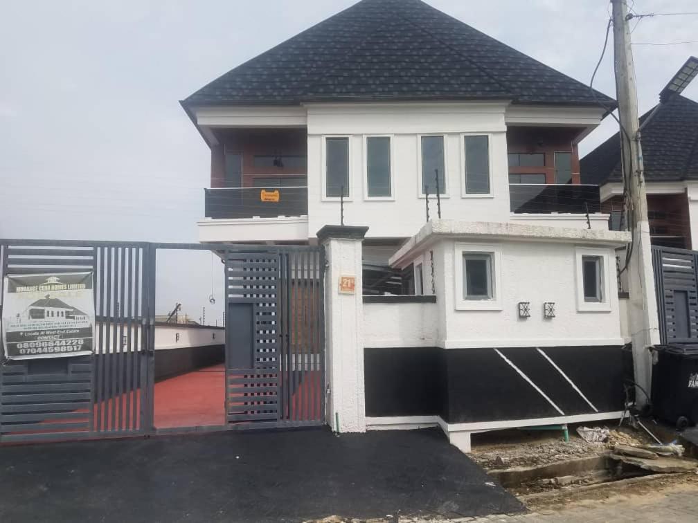 a white house with a gate in front of it at Mclanraysterlin in Lagos Island