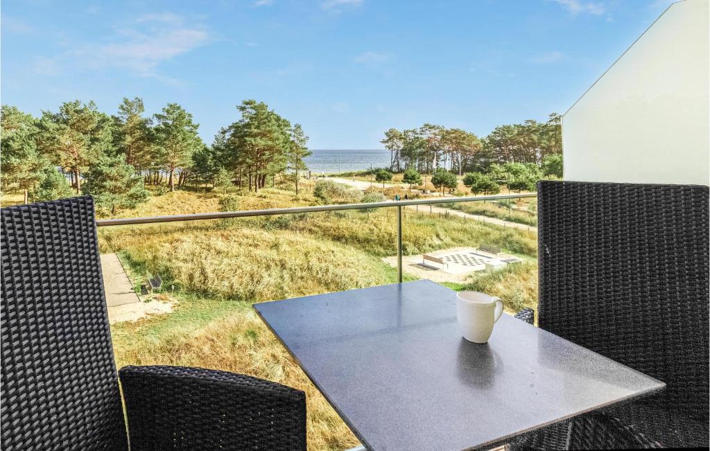 a coffee cup sitting on a table on a balcony with the ocean at Princess in Binz