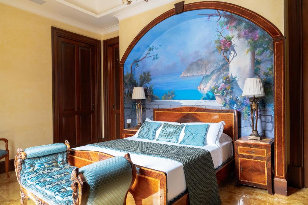 a bedroom with a bed with a painting on the wall at Casa Rajada Sorrento in Sorrento