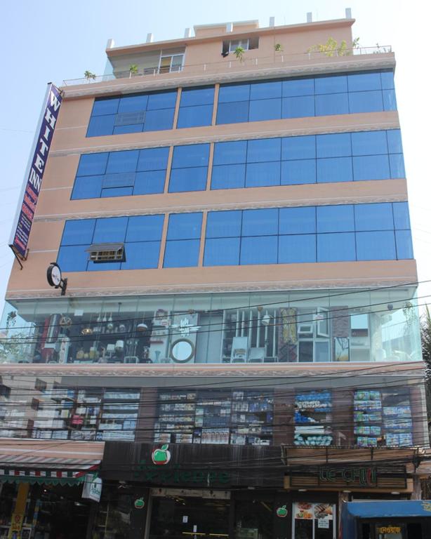 a tall building with a lot of windows at White Inn luxury Residential Hotel in Chittagong