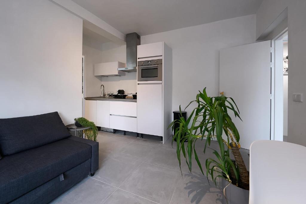 a living room with a couch and a kitchen at The Art Gallery - Mario's Place - By T&S in Eindhoven