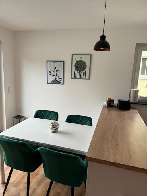 a kitchen with a white table and green chairs at Charmante 3ZimmerWhg in top Lage in Gießen