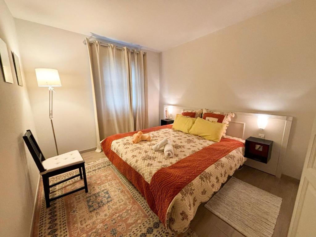 a bedroom with a bed with a dog laying on it at Joli T3 au pied du Golf - The 19th Hole in Bellême